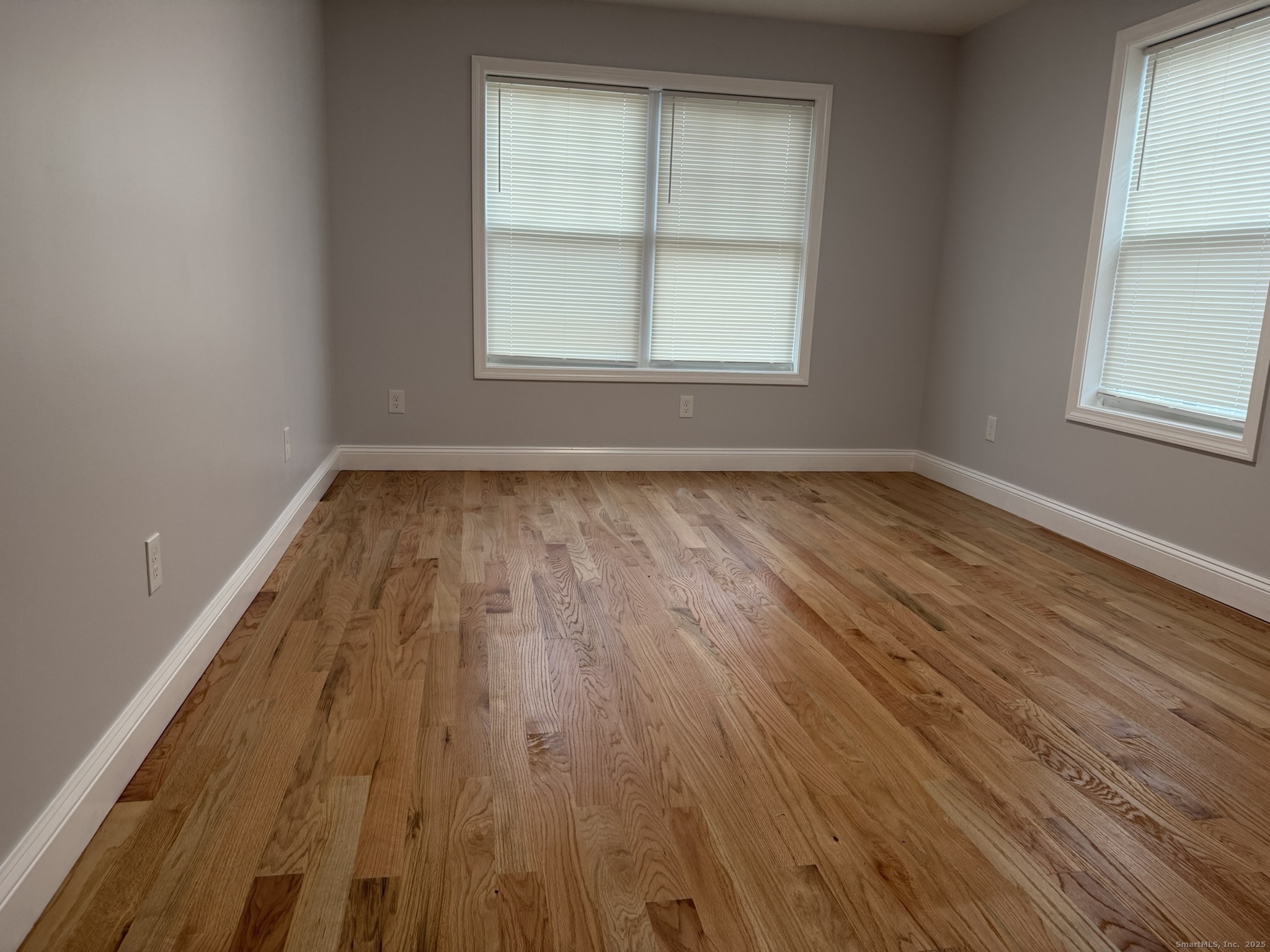 755 Hart Street Bridgeport, CT 06606 - Photo 15 of 37 an empty room with wooden floor and windows
