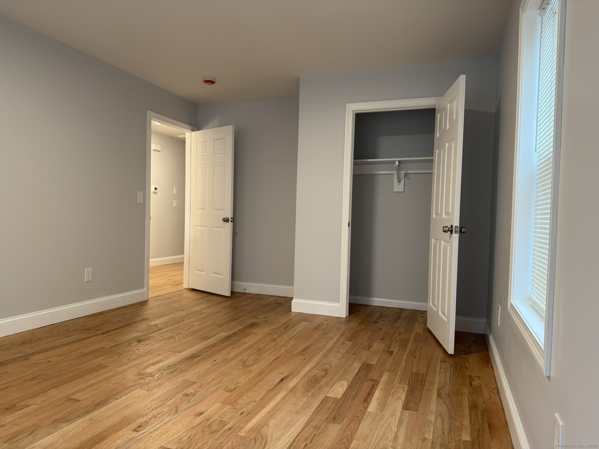 755 Hart Street Bridgeport, CT 06606 - Photo 16 of 37 an empty room with wooden floor and closet