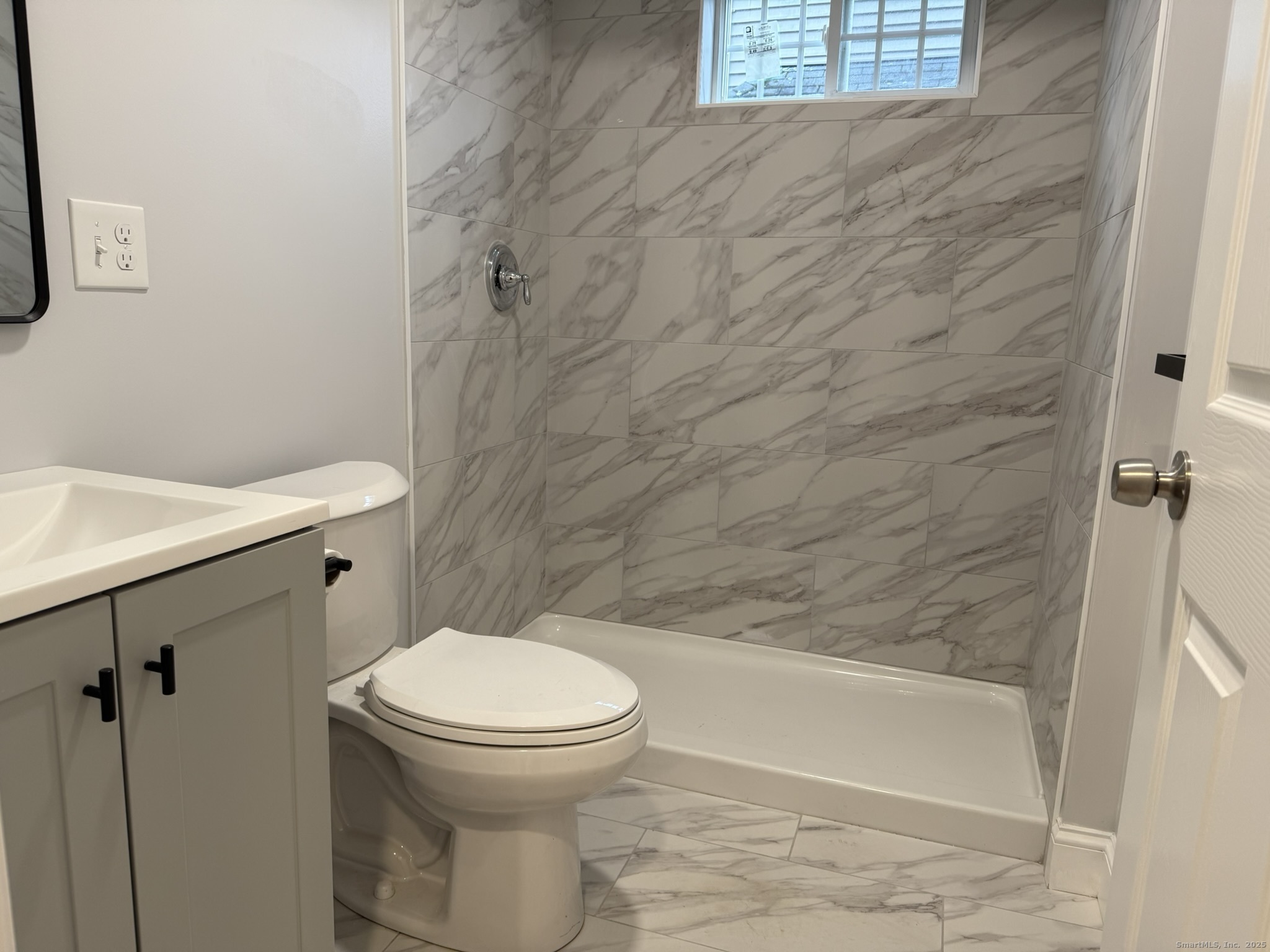 755 Hart Street Bridgeport, CT 06606 - Photo 22 of 37 a bathroom with a toilet a sink and shower