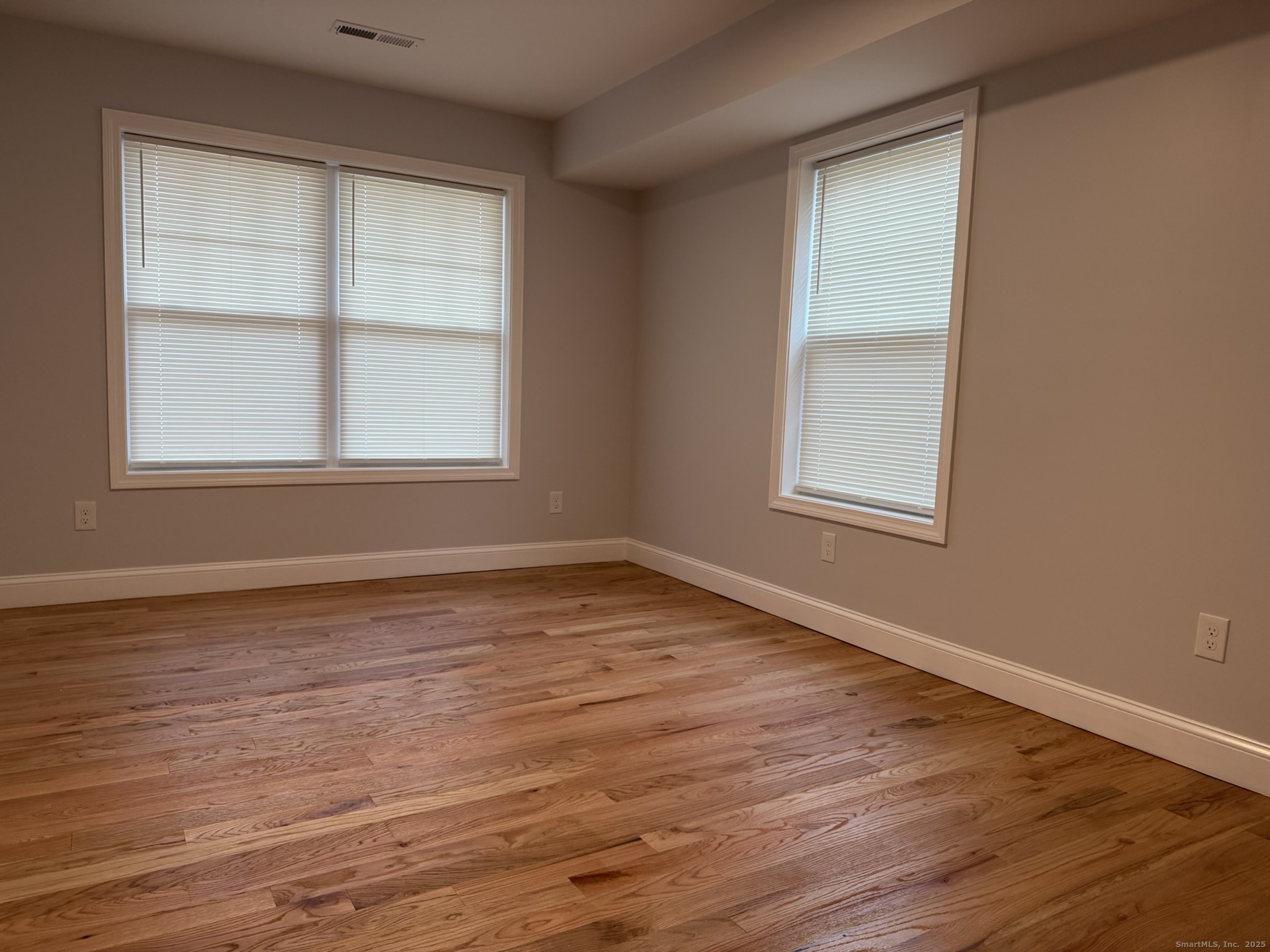 755 Hart Street Bridgeport, CT 06606 - Photo 24 of 37 an empty room with wooden floor and windows