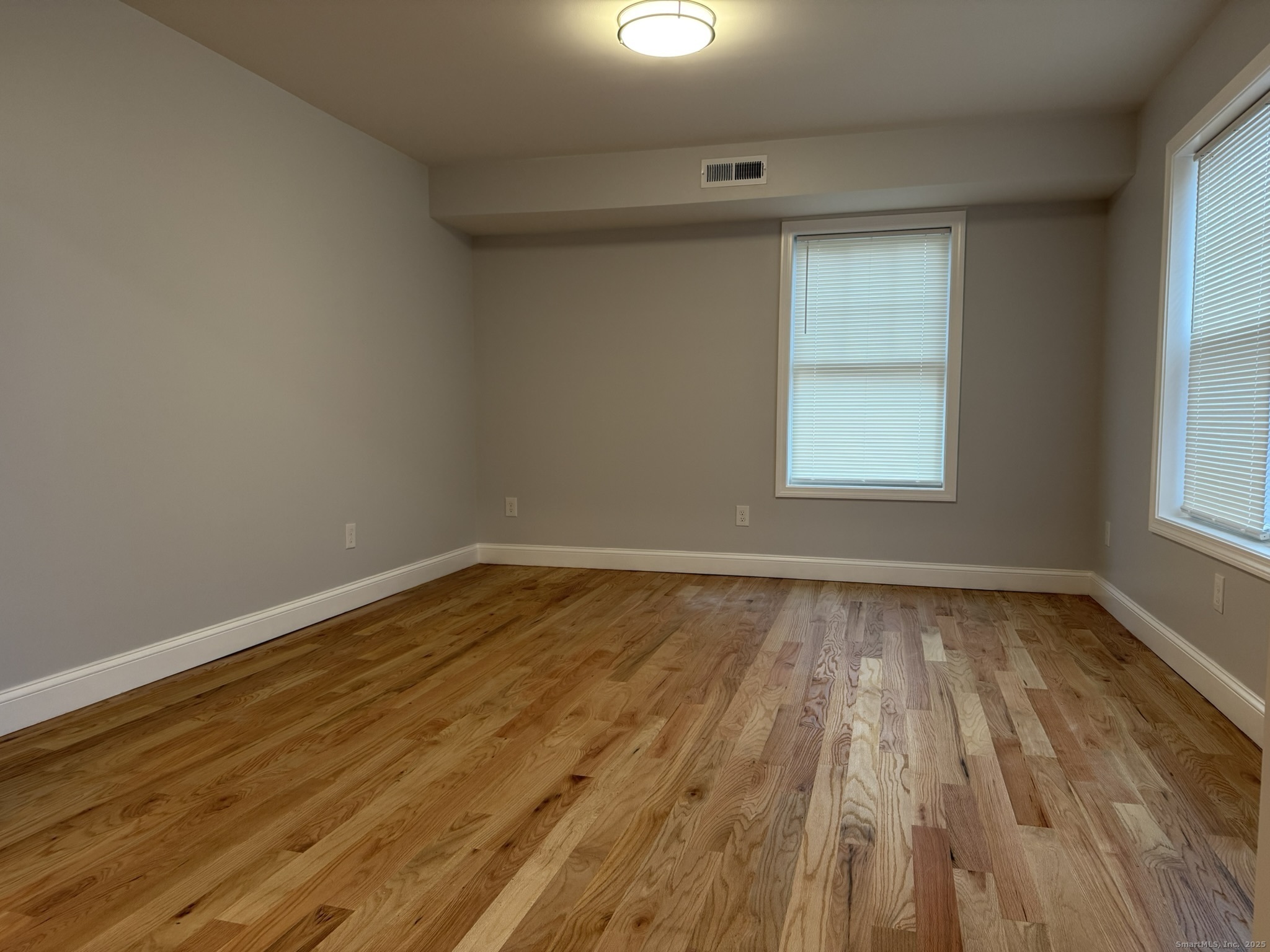 755 Hart Street Bridgeport, CT 06606 - Photo 26 of 37 wooden floor in an empty room with a window