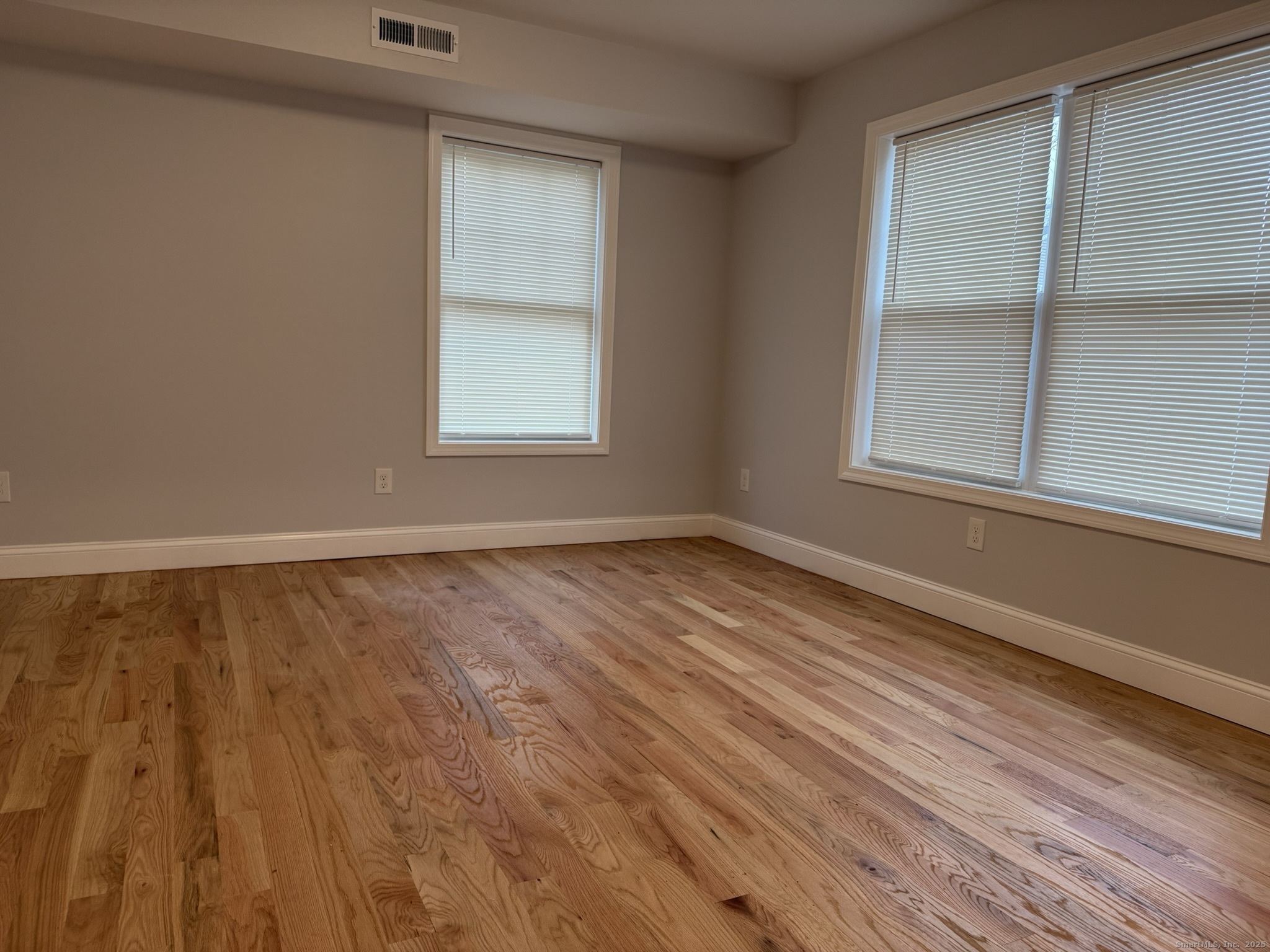 755 Hart Street Bridgeport, CT 06606 - Photo 27 of 37 a view of an empty room with wooden floor and a window