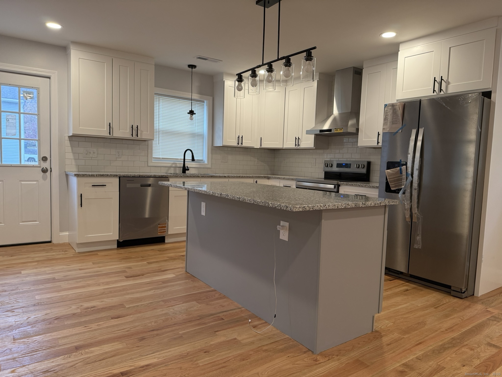 755 Hart Street Bridgeport, CT 06606 - Photo 29 of 37 a kitchen with stainless steel appliances granite countertop a refrigerator and a stove top oven