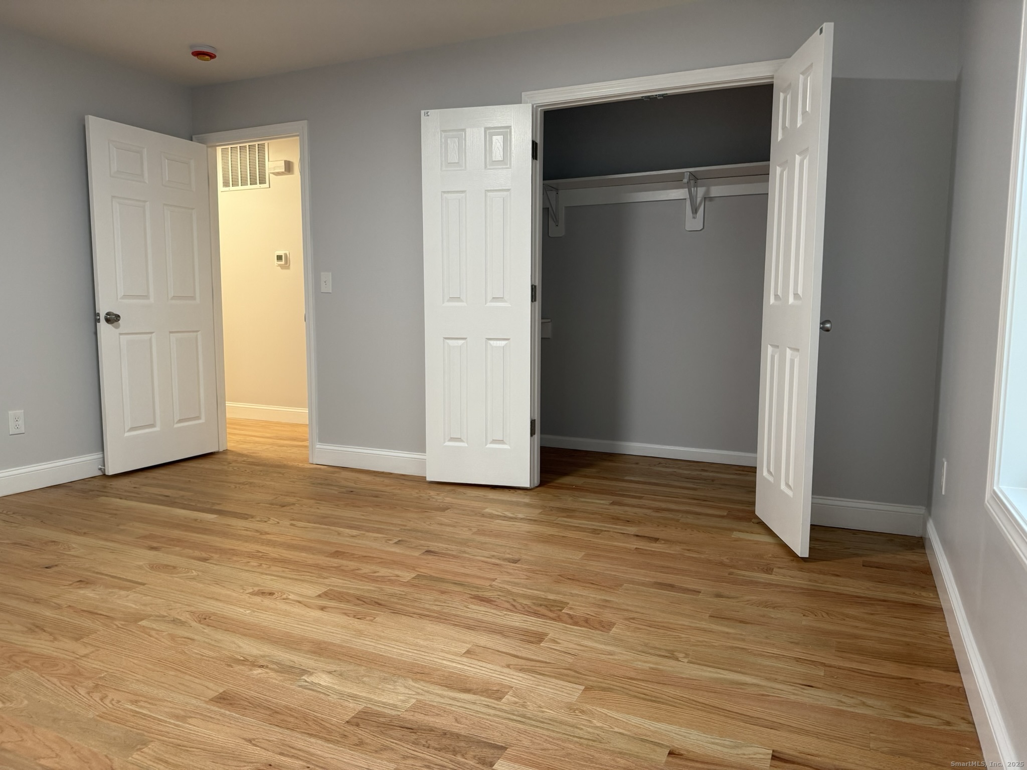 755 Hart Street Bridgeport, CT 06606 - Photo 10 of 37 an empty room with wooden floor and closet area