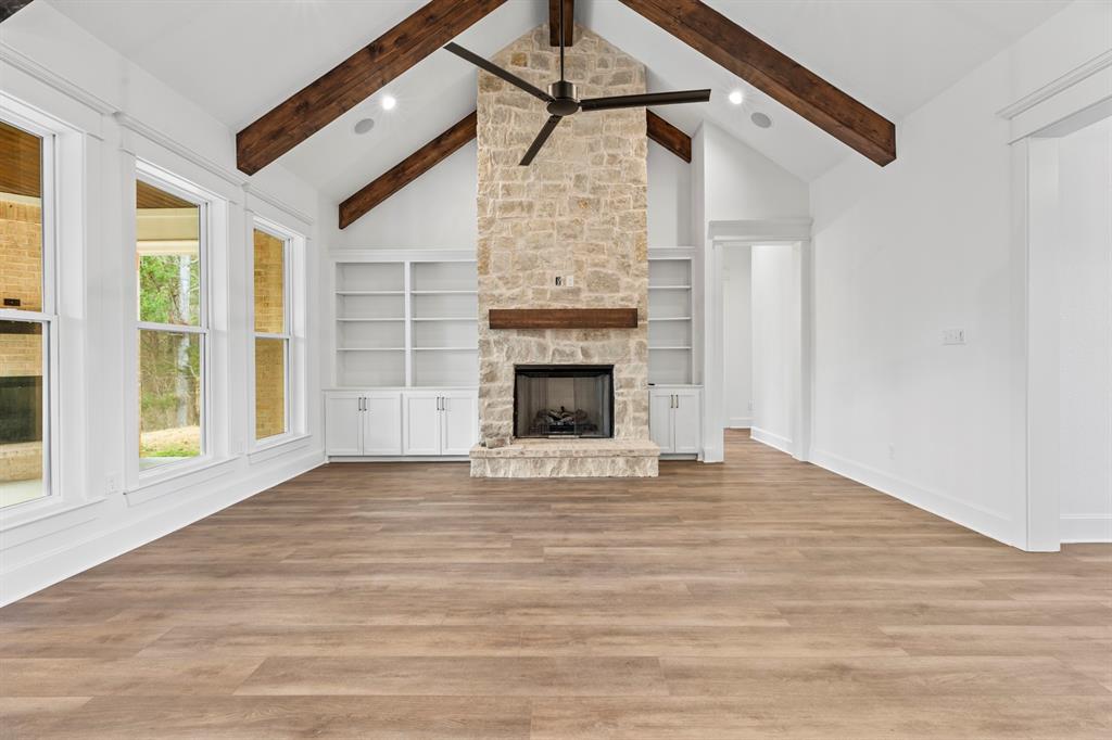 12171 Copper Court Tyler, TX 75706 - Photo 14 of 40 a view of empty room with fireplace and wooden floor