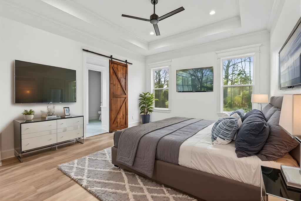 12171 Copper Court Tyler, TX 75706 - Photo 20 of 40 a bedroom with a flat screen television and a bed