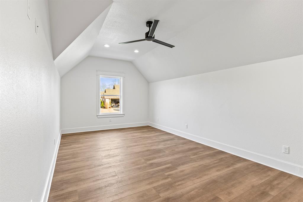 12171 Copper Court Tyler, TX 75706 - Photo 28 of 40 an empty room with wooden floor ceiling fan and windows