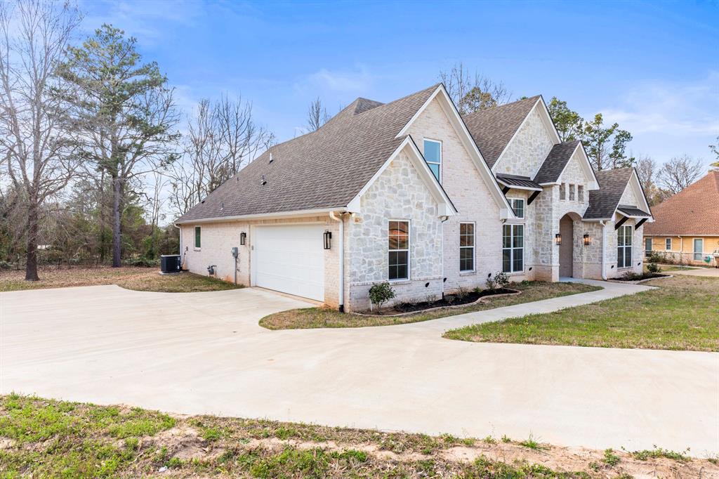 12171 Copper Court Tyler, TX 75706 - Photo 3 of 40 a view of a white house with a big yard and large tree
