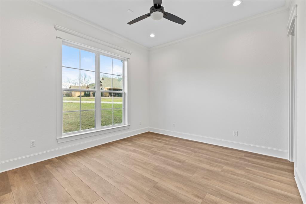 12171 Copper Court Tyler, TX 75706 - Photo 32 of 40 an empty room with wooden floor cabinet and windows