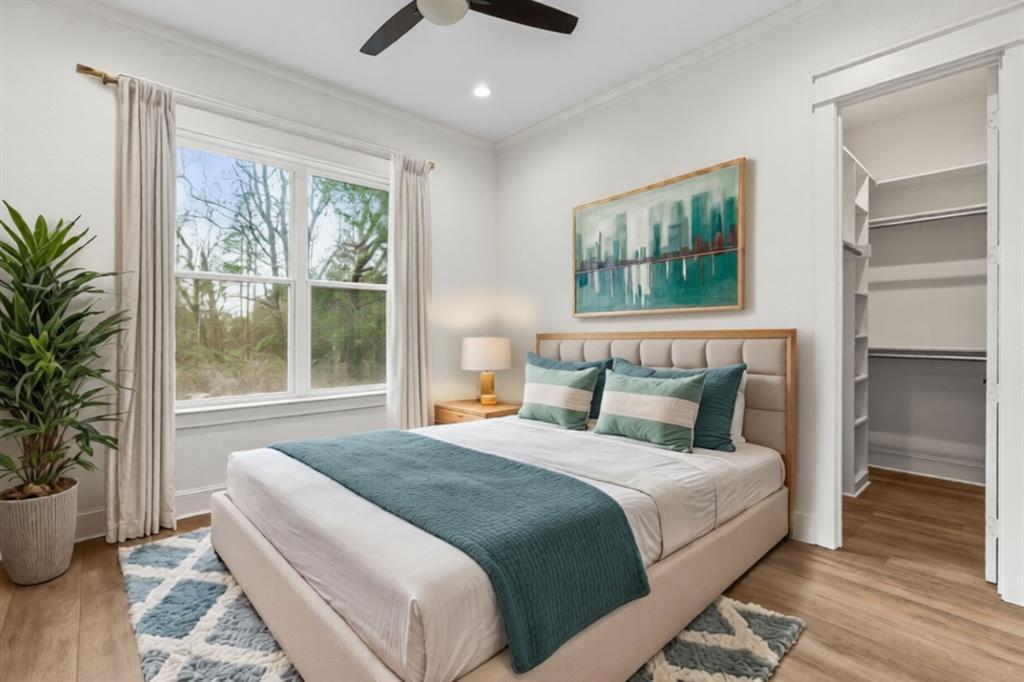 12171 Copper Court Tyler, TX 75706 - Photo 36 of 40 a bedroom with a large bed and a potted plant