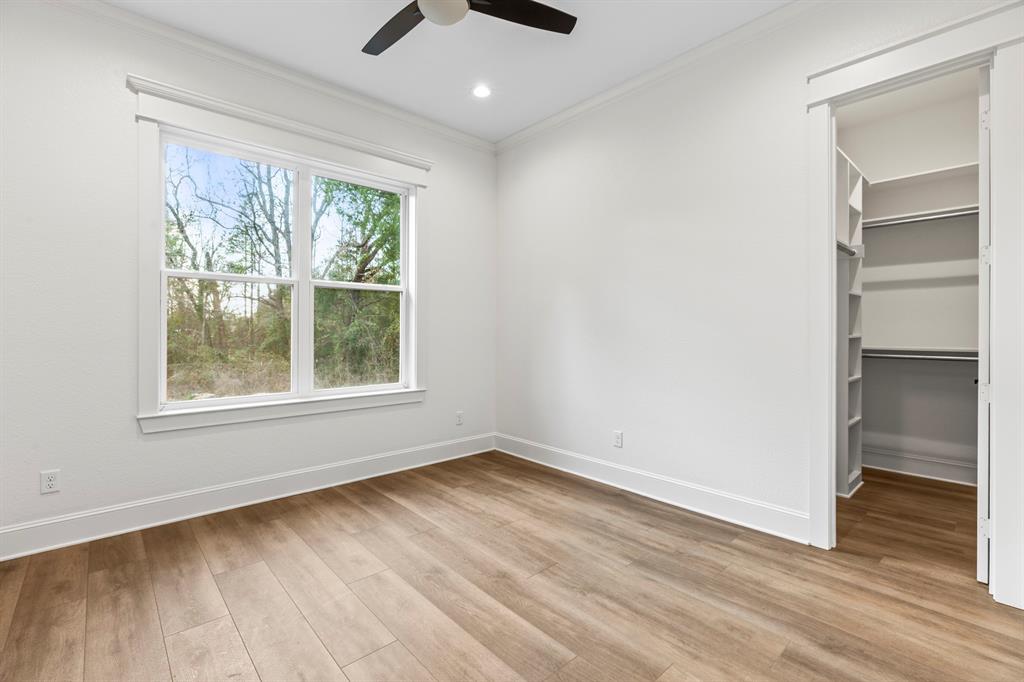 12171 Copper Court Tyler, TX 75706 - Photo 37 of 40 an empty room with wooden floor and windows
