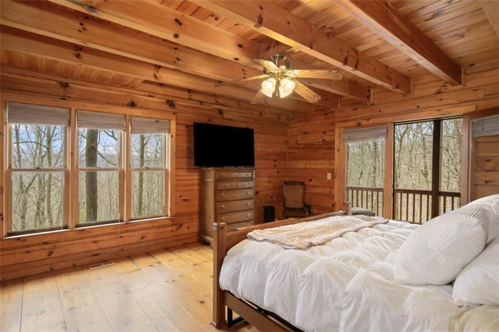 541 Little Bushy Head Road Blue Ridge, GA 30513 - Photo 14 of 43 a bedroom with a bed and a flat screen tv