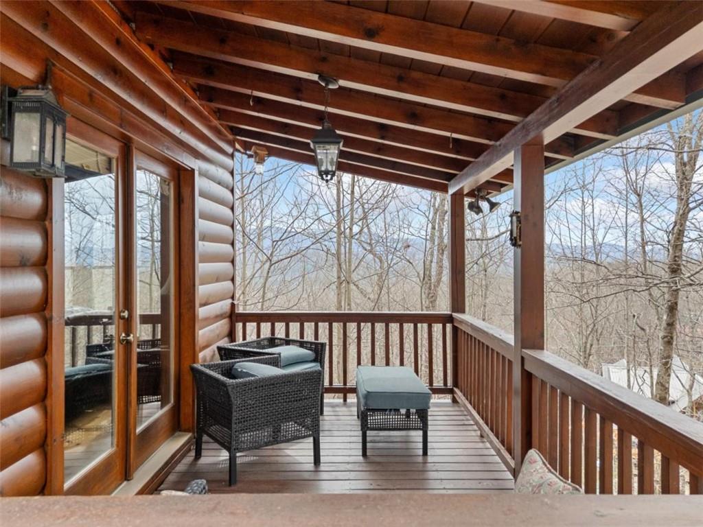 541 Little Bushy Head Road Blue Ridge, GA 30513 - Photo 2 of 43 a view of a chairs and table in the balcony