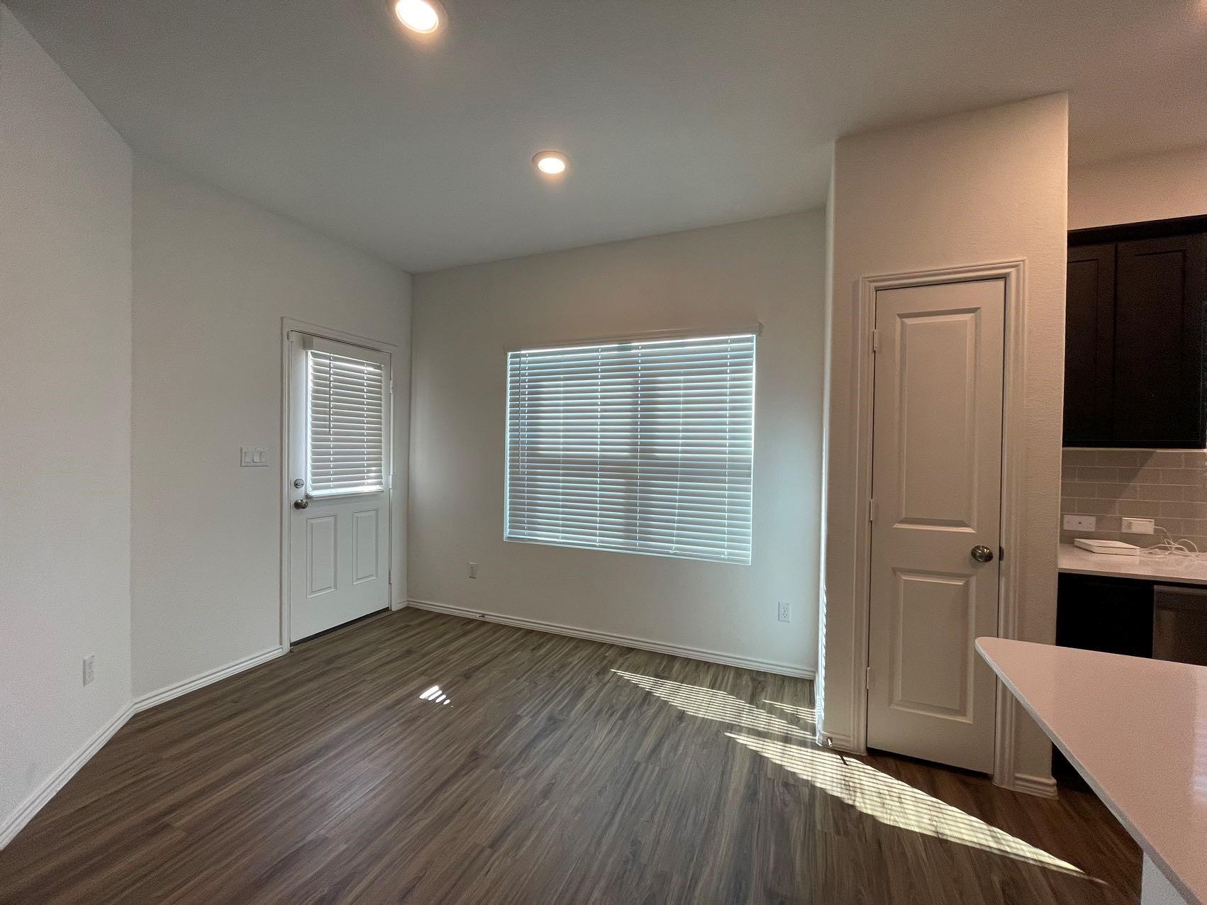1625 Woolsey Way Leander, TX 78641 - Photo 5 of 17 This living area features recessed lighting, durable wood-look flooring, and a bright window with blinds