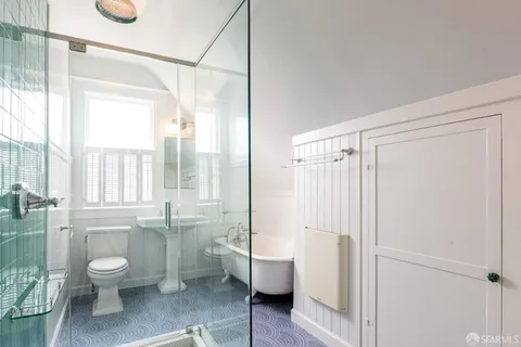 a bathroom with a granite countertop toilet a sink and a bathtub