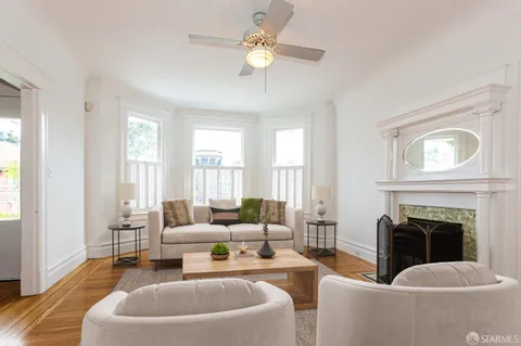a living room with furniture a fireplace and a chandelier