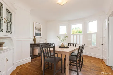 a view of a dining room with furniture and window