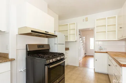 a kitchen with granite countertop a stove and a refrigerator