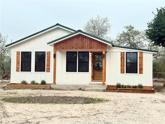 a view of a house with snow on the background