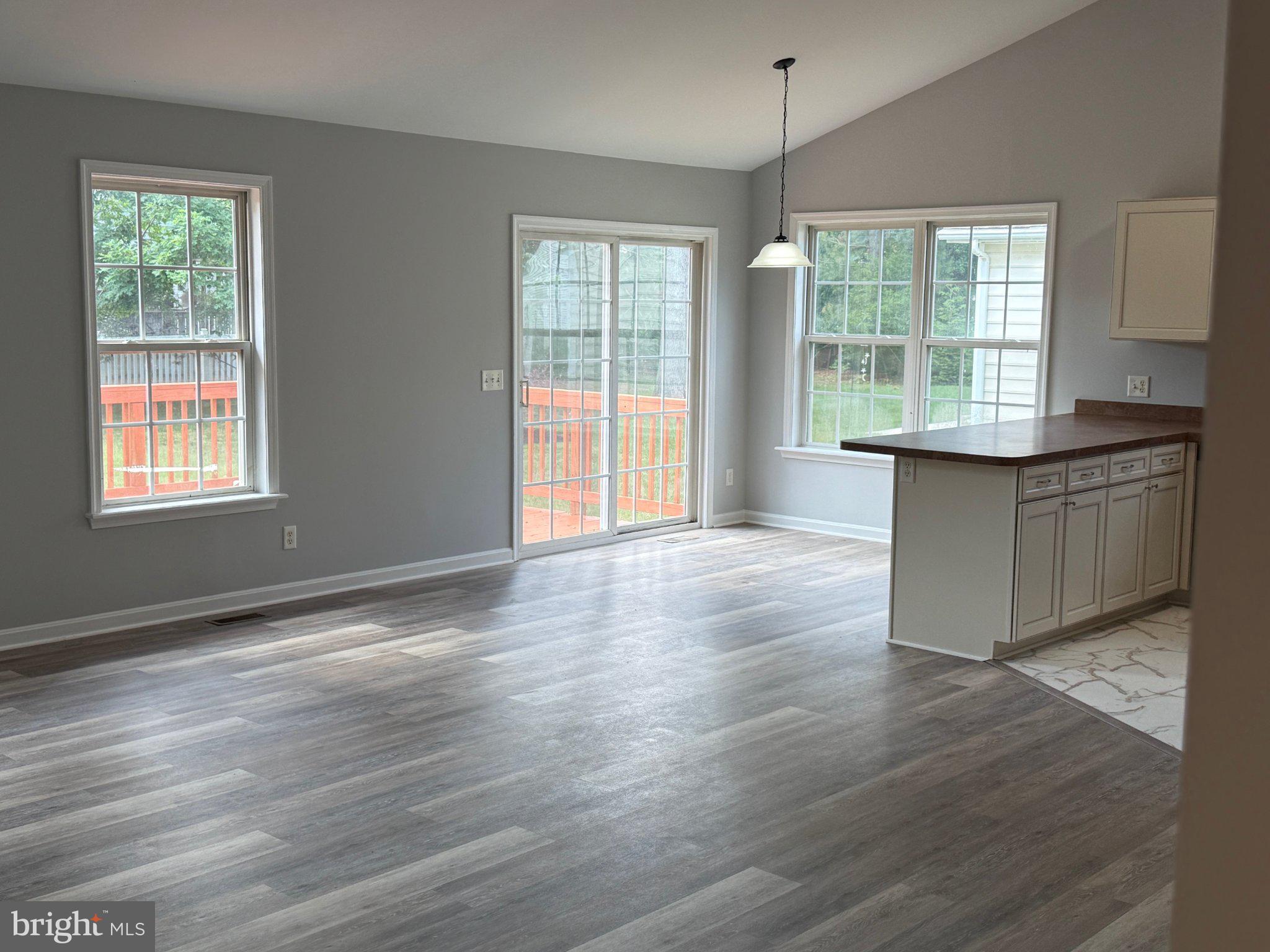 30952 Sandy Ridge Drive Lewes, DE 19958 - Photo 6 of 17 an empty room with wooden floor and windows