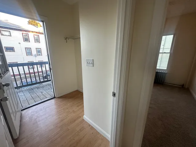 a view of a room with wooden floor and windows