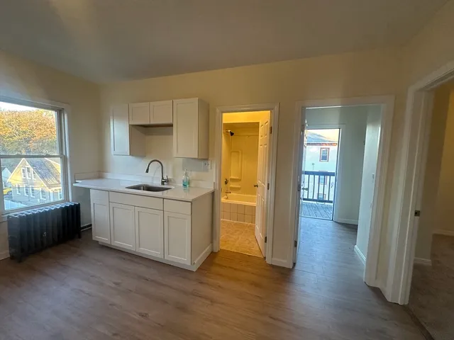 a kitchen with sink and cabinets