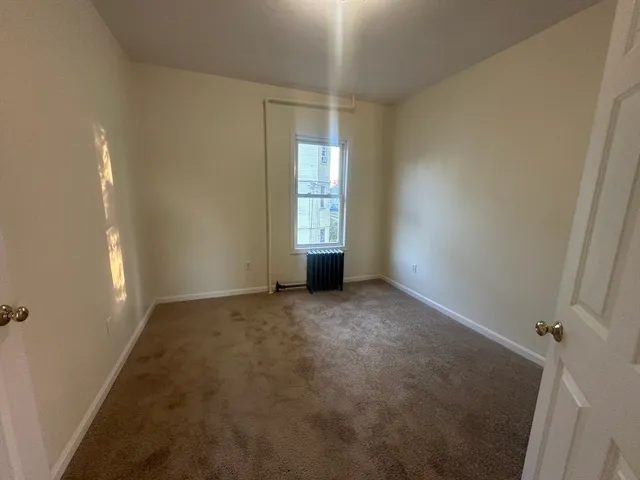 a view of an empty room and a window