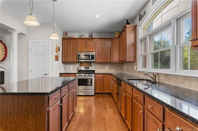a living room with lots of furniture and kitchen view