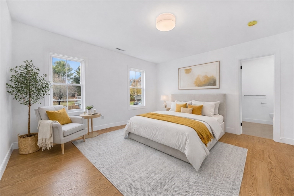 25 Irving Road Natick, MA 01760 - Photo 20 of 37 a spacious bedroom with a bed and a couch