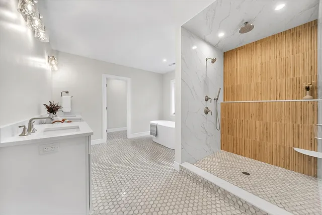 a bathroom with a sink a toilet and shower