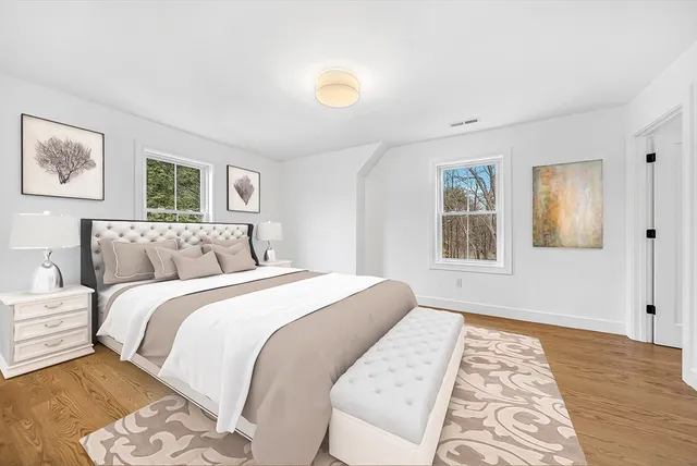 a bedroom with a large bed and a window