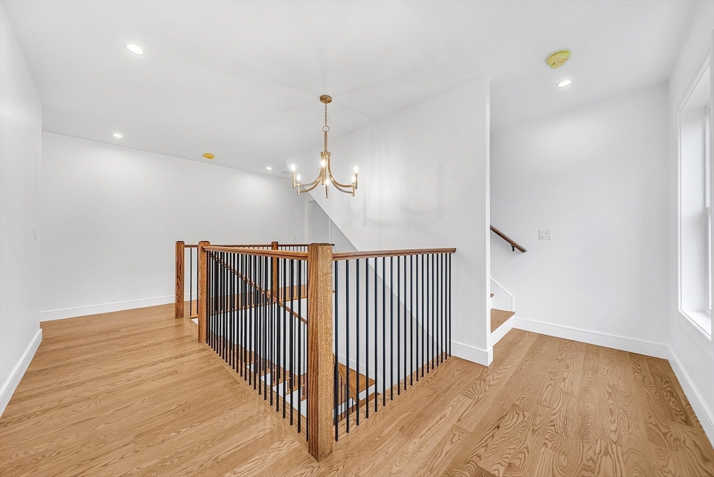 25 Irving Road Natick, MA 01760 - Photo 28 of 37 a view of a hallway with wooden floor and stairs