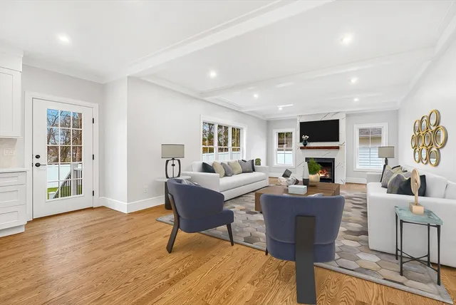 a living room with furniture a fireplace and a flat screen tv