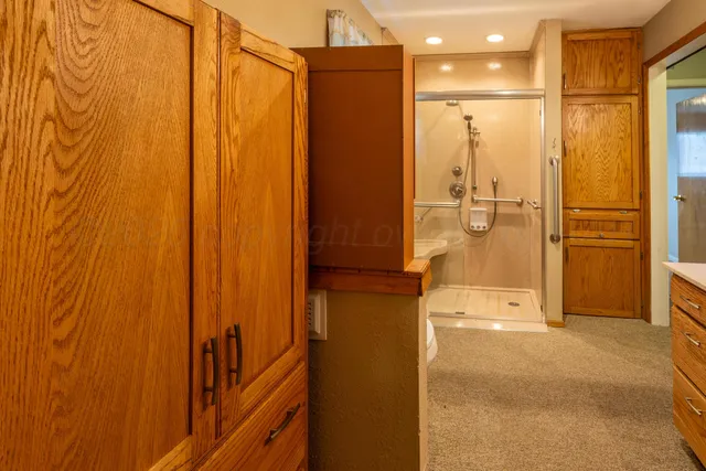 a view of a hallway with a bathroom