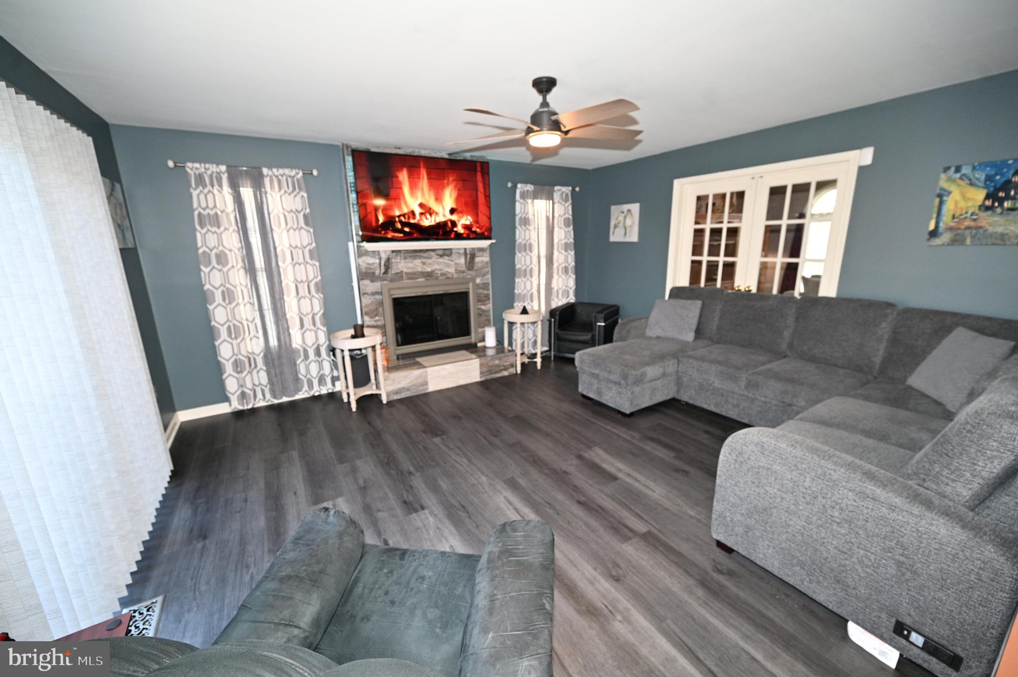 7729 Castle Rock Drive Clinton, MD 20735 - Photo 16 of 65 a living room with furniture and a flat screen tv