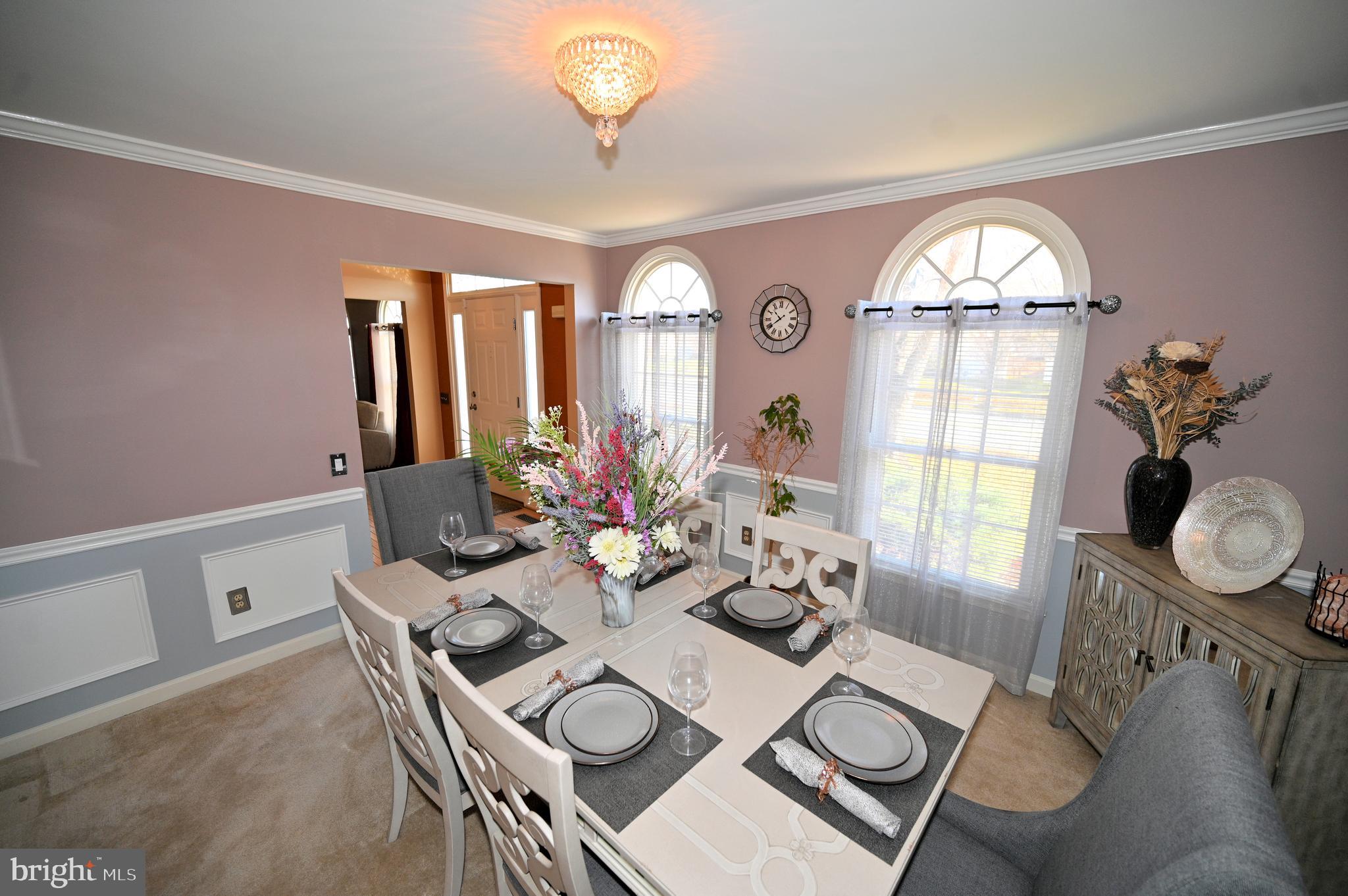 7729 Castle Rock Drive Clinton, MD 20735 - Photo 17 of 65 a view of a dining room with furniture a chandelier and wooden floor