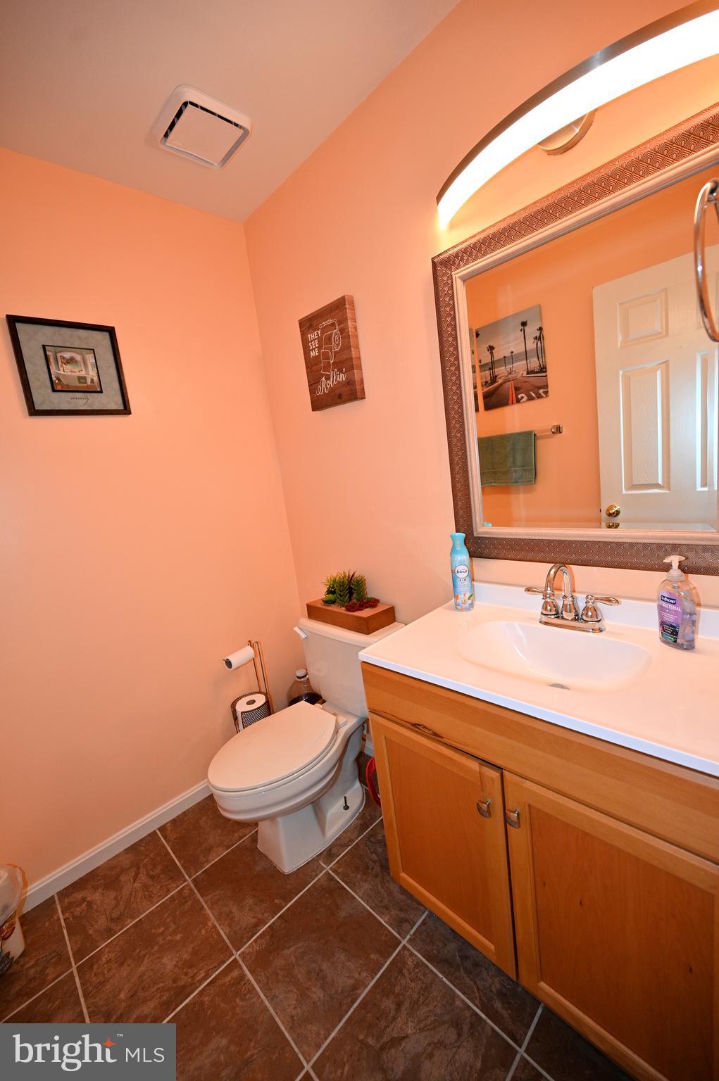 7729 Castle Rock Drive Clinton, MD 20735 - Photo 23 of 65 a bathroom with a toilet sink and mirror