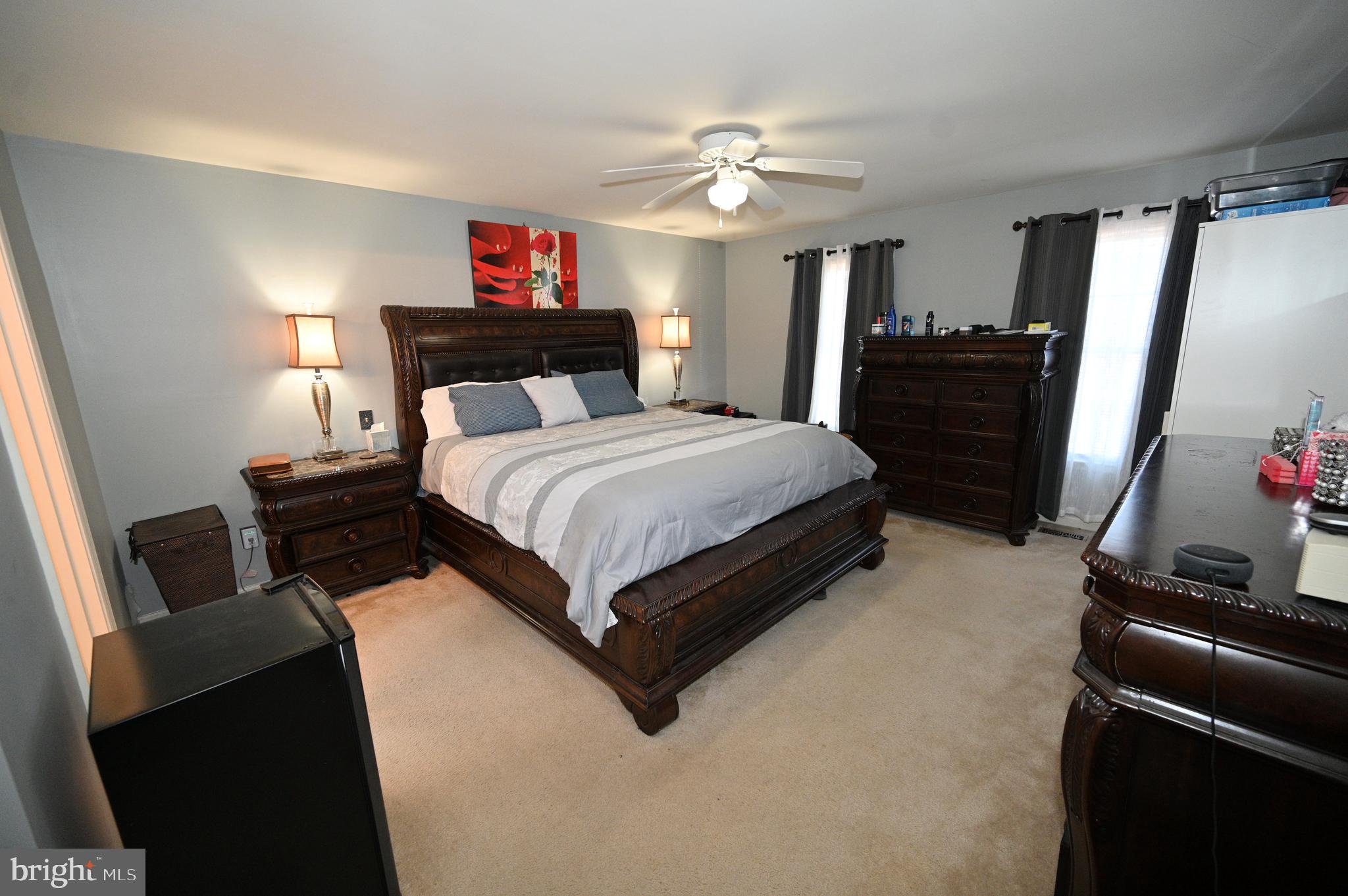 7729 Castle Rock Drive Clinton, MD 20735 - Photo 26 of 65 a spacious bedroom with a bed and a chandelier