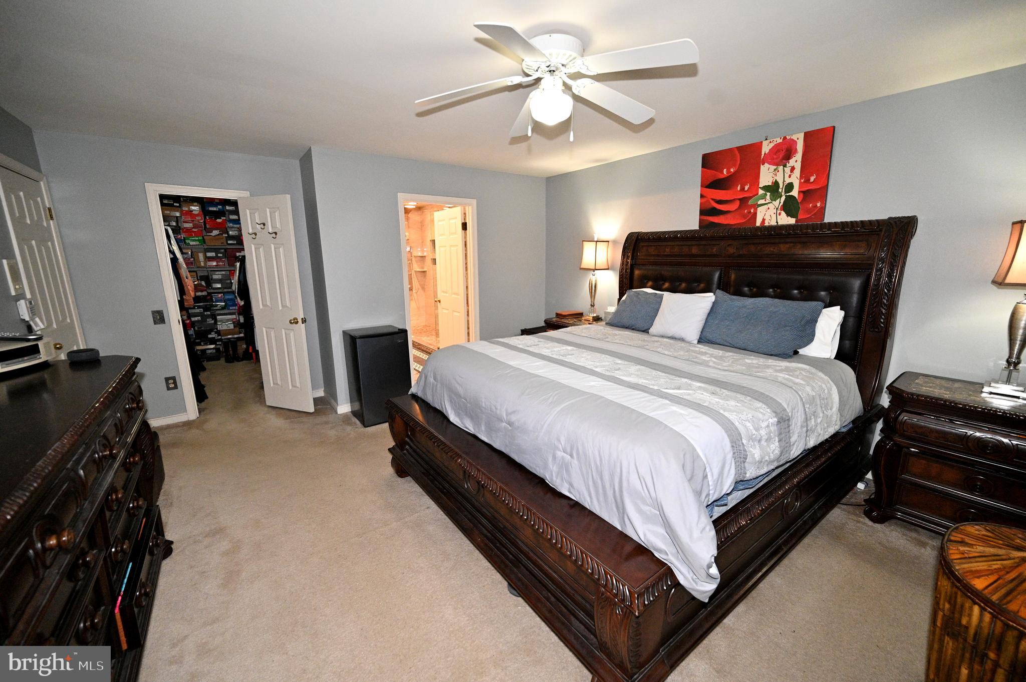 7729 Castle Rock Drive Clinton, MD 20735 - Photo 27 of 65 a bedroom with a bed and a chandelier