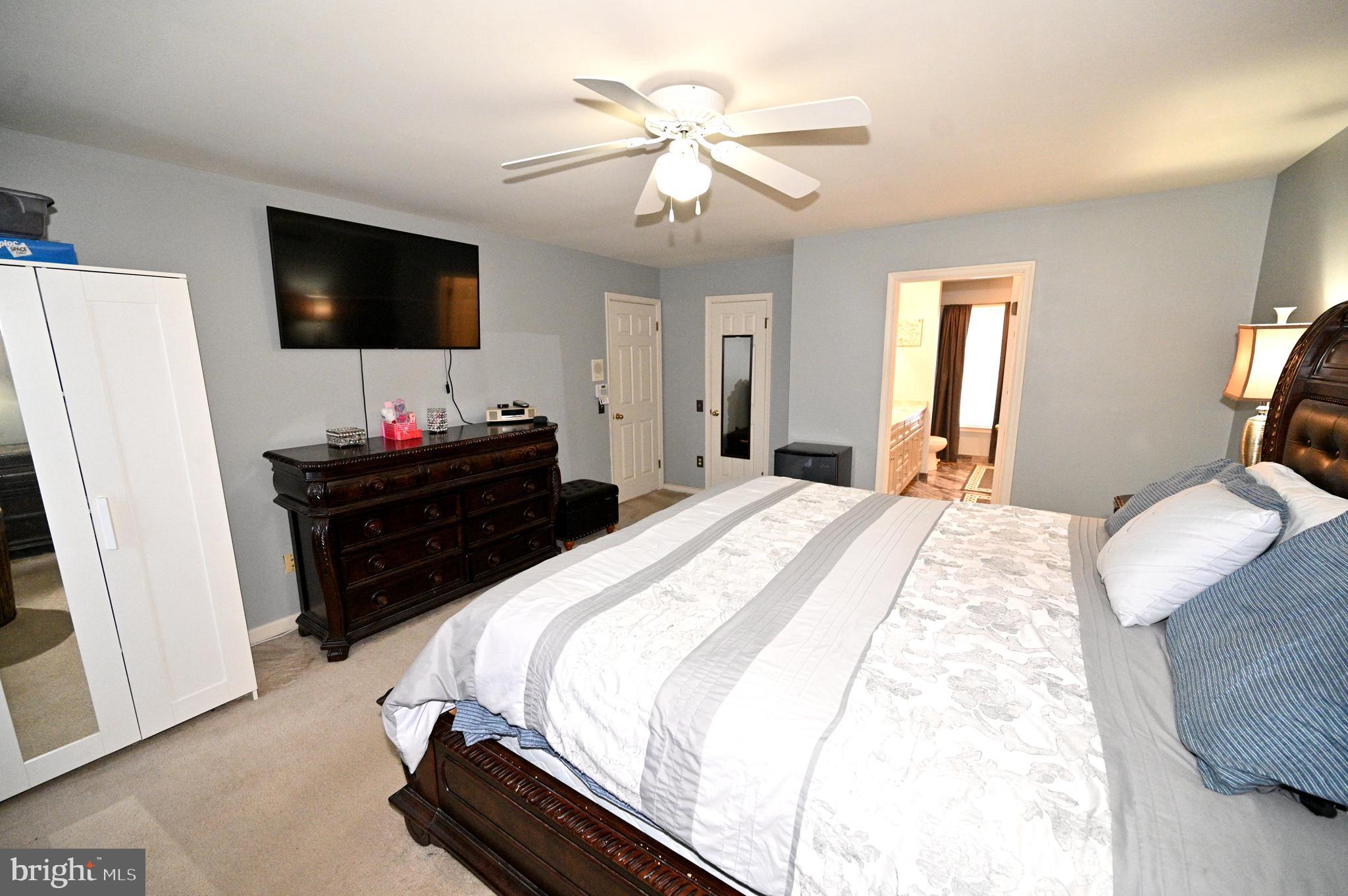 7729 Castle Rock Drive Clinton, MD 20735 - Photo 30 of 65 a bedroom with a bed and a flat screen tv