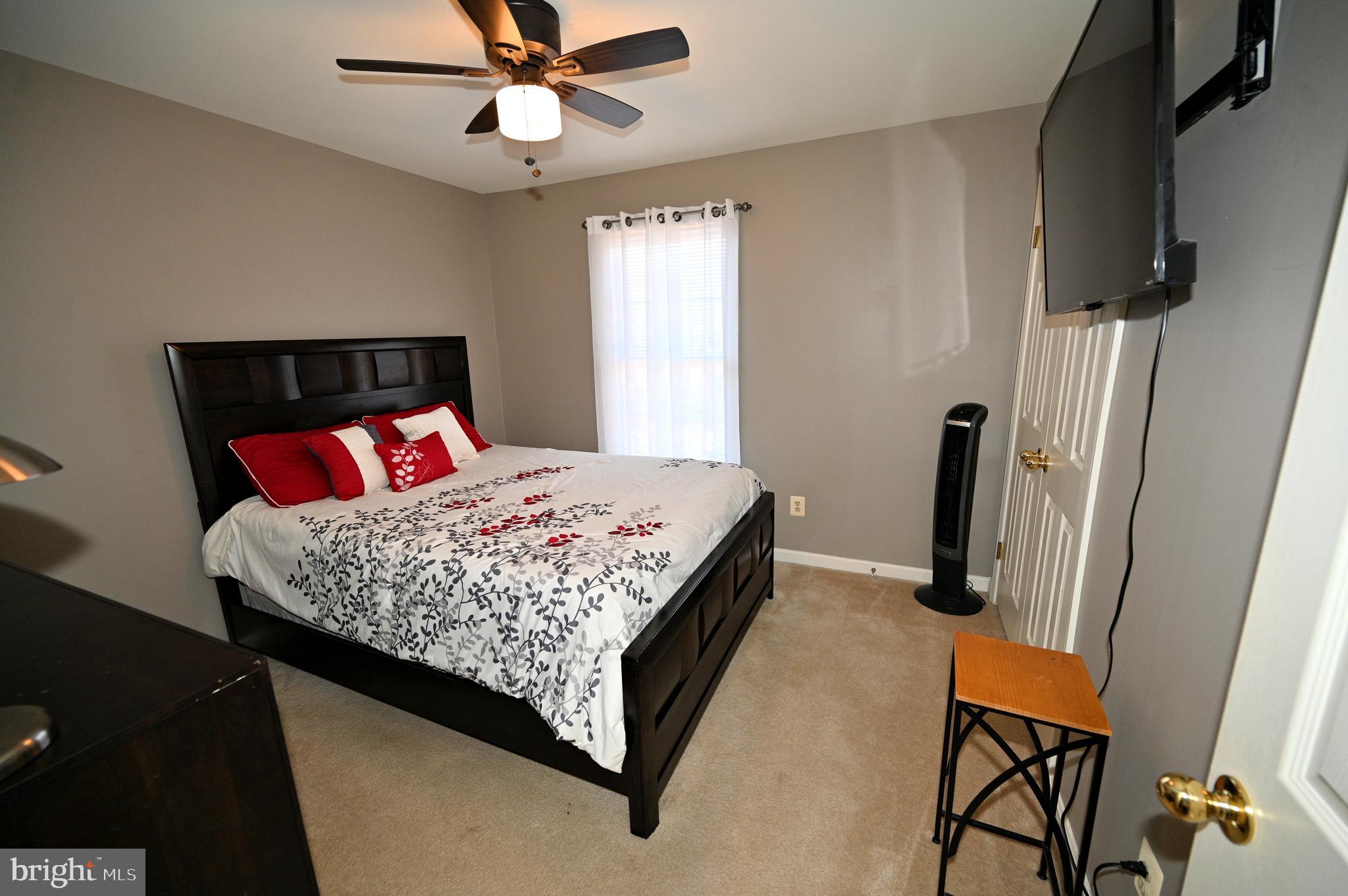 7729 Castle Rock Drive Clinton, MD 20735 - Photo 35 of 65 a bedroom with a bed and a flat screen tv