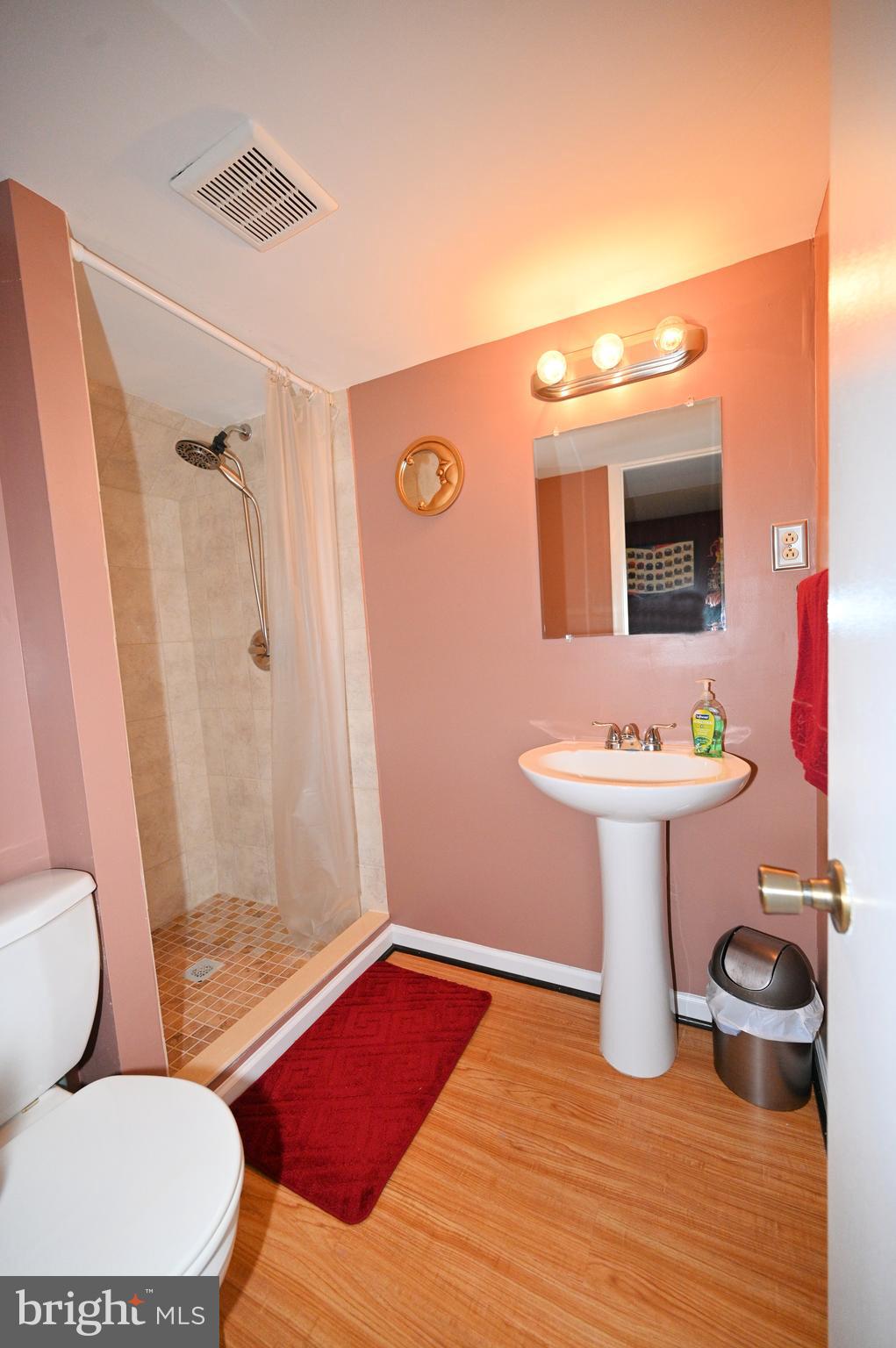 7729 Castle Rock Drive Clinton, MD 20735 - Photo 36 of 65 a bathroom with a sink toilet a mirror and shower