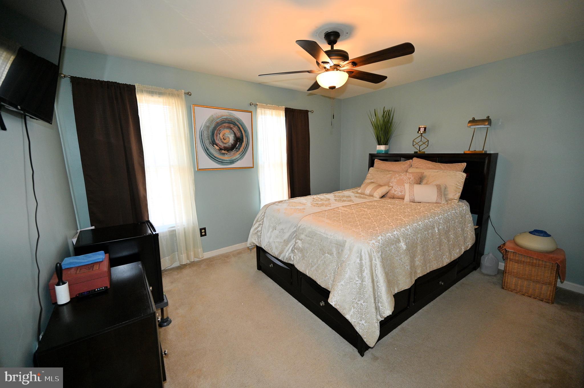 7729 Castle Rock Drive Clinton, MD 20735 - Photo 38 of 65 a bedroom with a bed and a chandelier