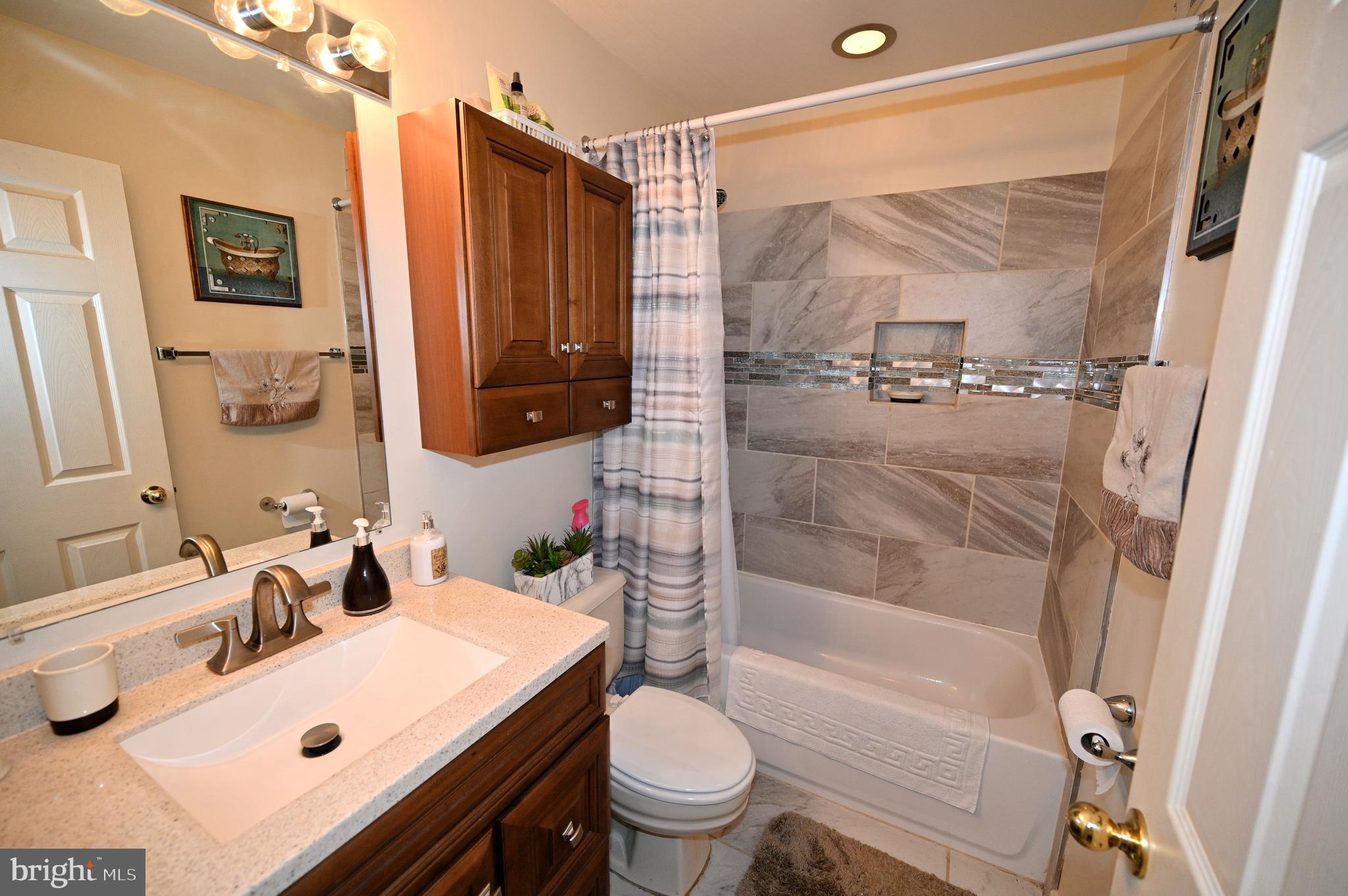 7729 Castle Rock Drive Clinton, MD 20735 - Photo 39 of 65 a bathroom with a sink toilet and shower