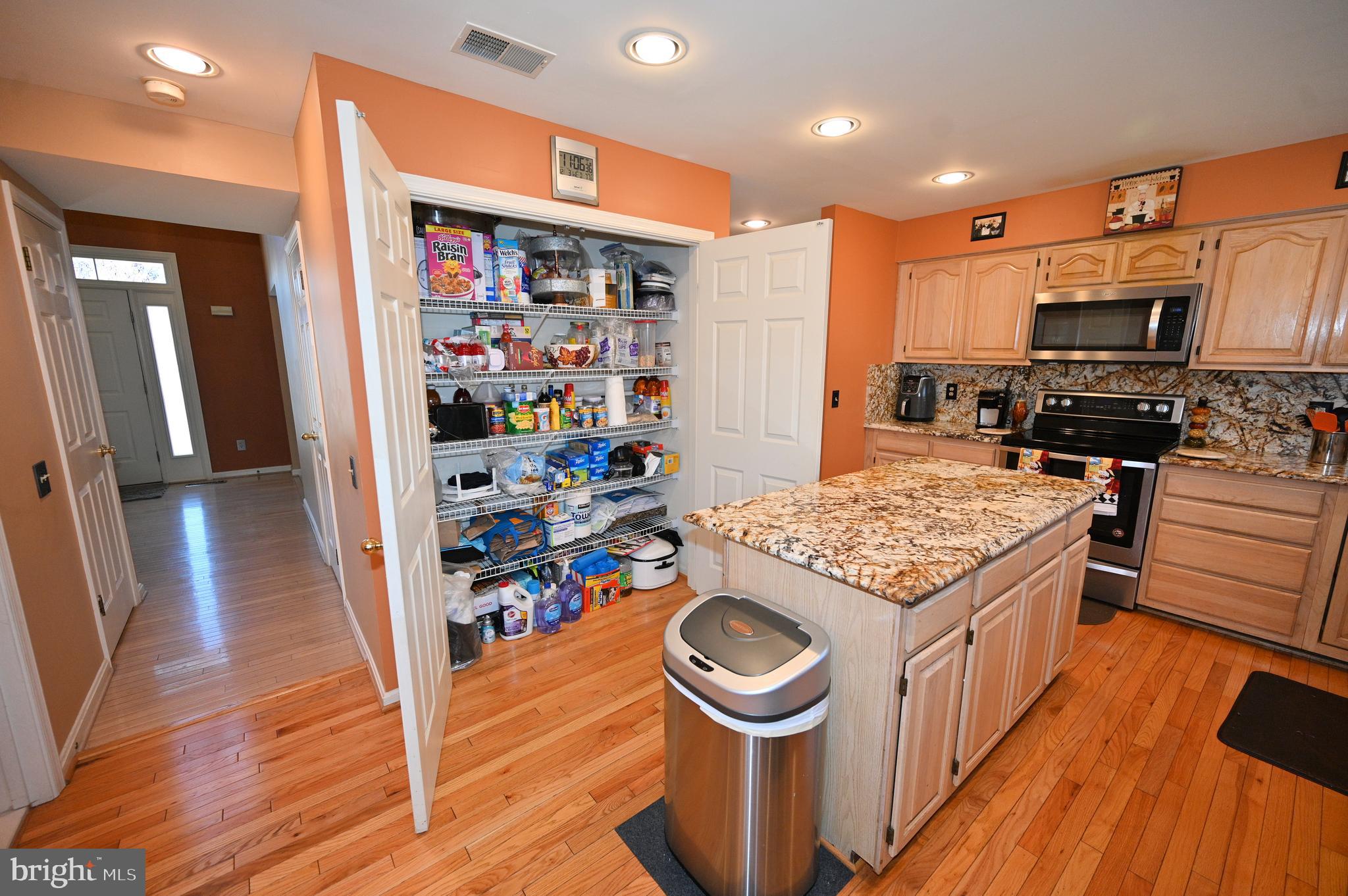 7729 Castle Rock Drive Clinton, MD 20735 - Photo 4 of 65 a kitchen with stainless steel appliances granite countertop a sink stove and wooden floor