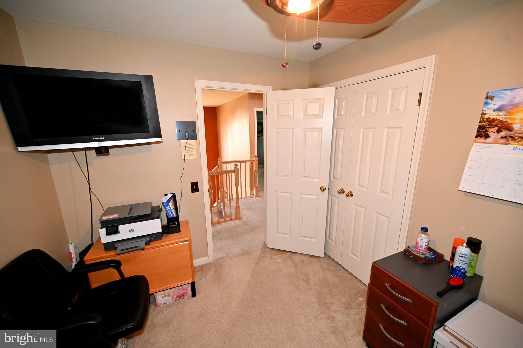 7729 Castle Rock Drive Clinton, MD 20735 - Photo 57 of 65 a living room with furniture and a flat screen tv