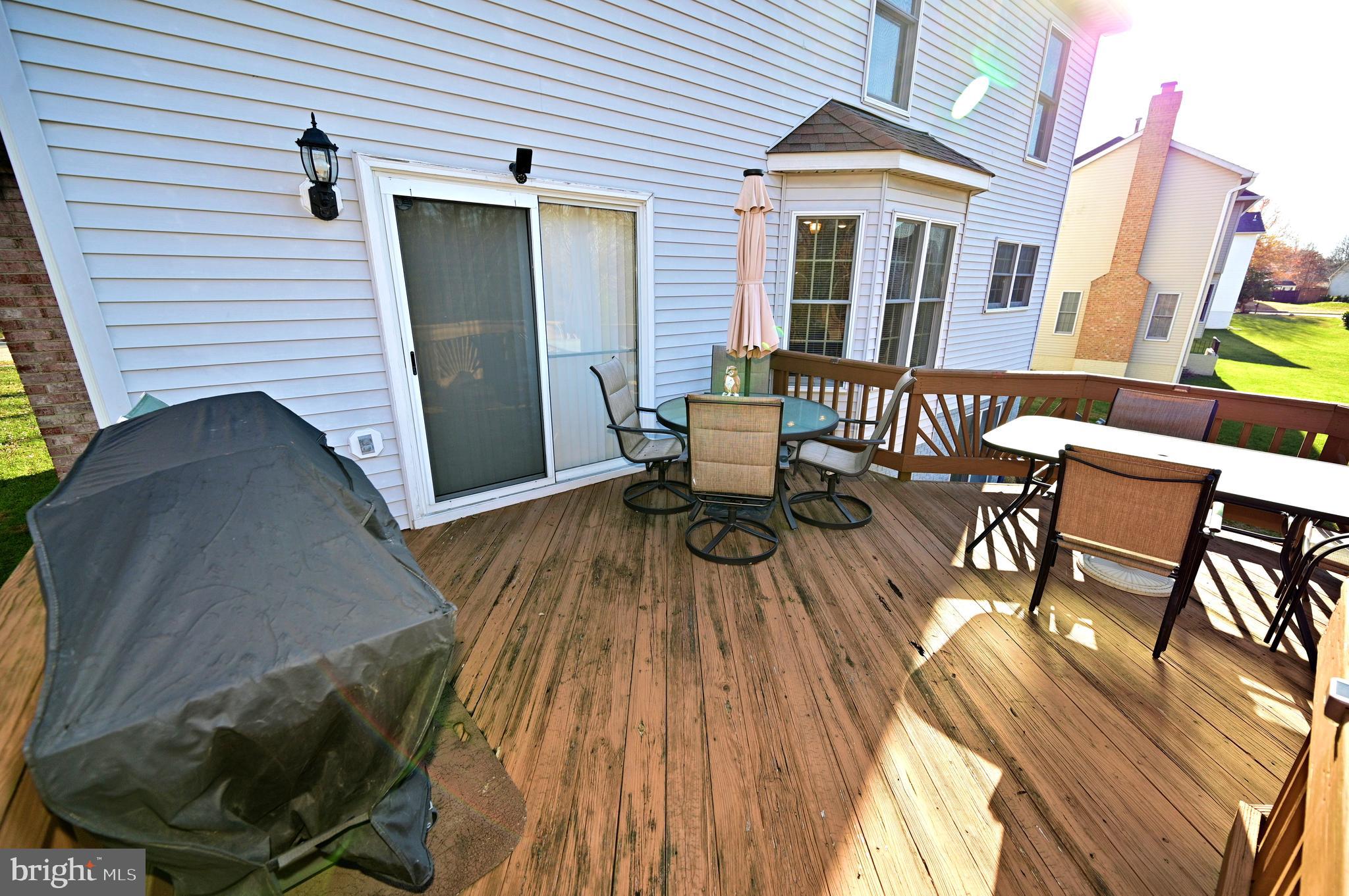 7729 Castle Rock Drive Clinton, MD 20735 - Photo 59 of 65 a view of a patio with table and chairs and wooden floor