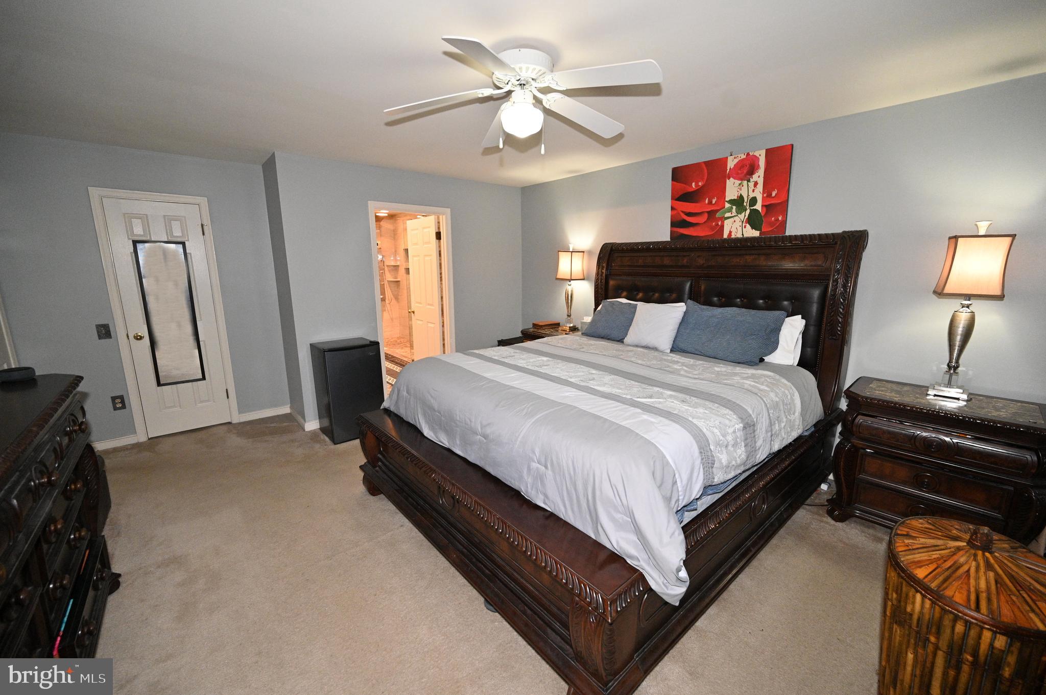 7729 Castle Rock Drive Clinton, MD 20735 - Photo 62 of 65 a bed room with a bed and a chandelier