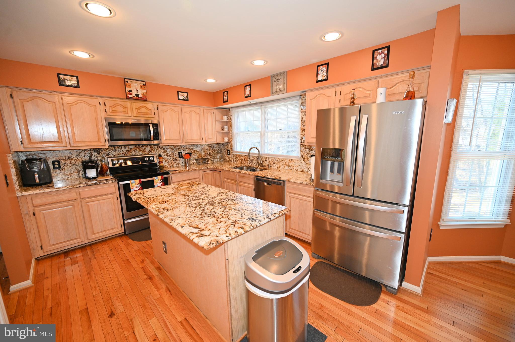 7729 Castle Rock Drive Clinton, MD 20735 - Photo 7 of 65 a kitchen with stainless steel appliances granite countertop a refrigerator a stove top oven a sink and dishwasher