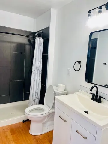 a bathroom with a sink toilet and shower